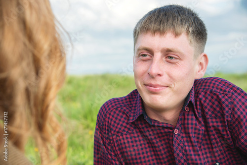 Young couple on a picnic in a beautiful place under the open sky.