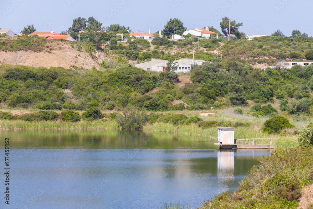 Houses, lake and trail in mountain in Arrifana