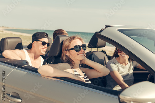 Smiling friends driving car near the sea and having fun © fotofabrika