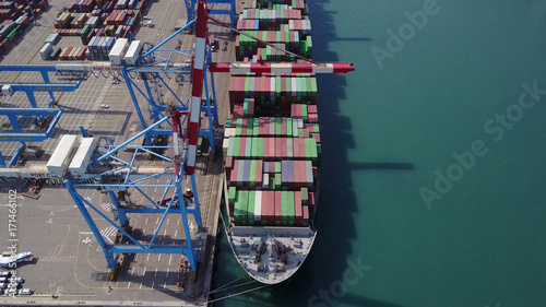 Fully loaded container ship docked at freight port terminal