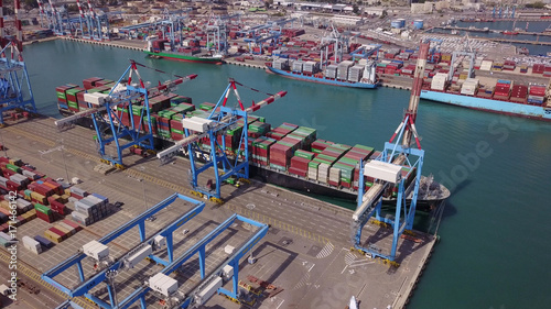 Fully loaded container ship docked at freight port terminal