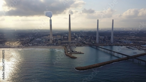 Big coal power station with tall chimnies and coal conductor and white steam - aerial shot