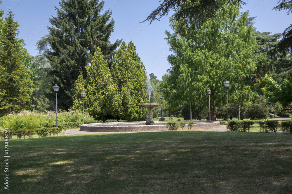 Public city park in Ferrara with old magic fountain