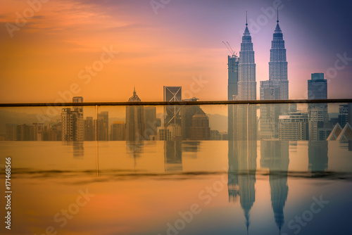 Photography Cityscape of Kuala lumpur city skyline with swimming pool on the roof top of hotel at sunrise in Malaysia
