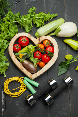 Diet. Sport and a healthy lifestyle. Fresh vegetables on a black wooden background