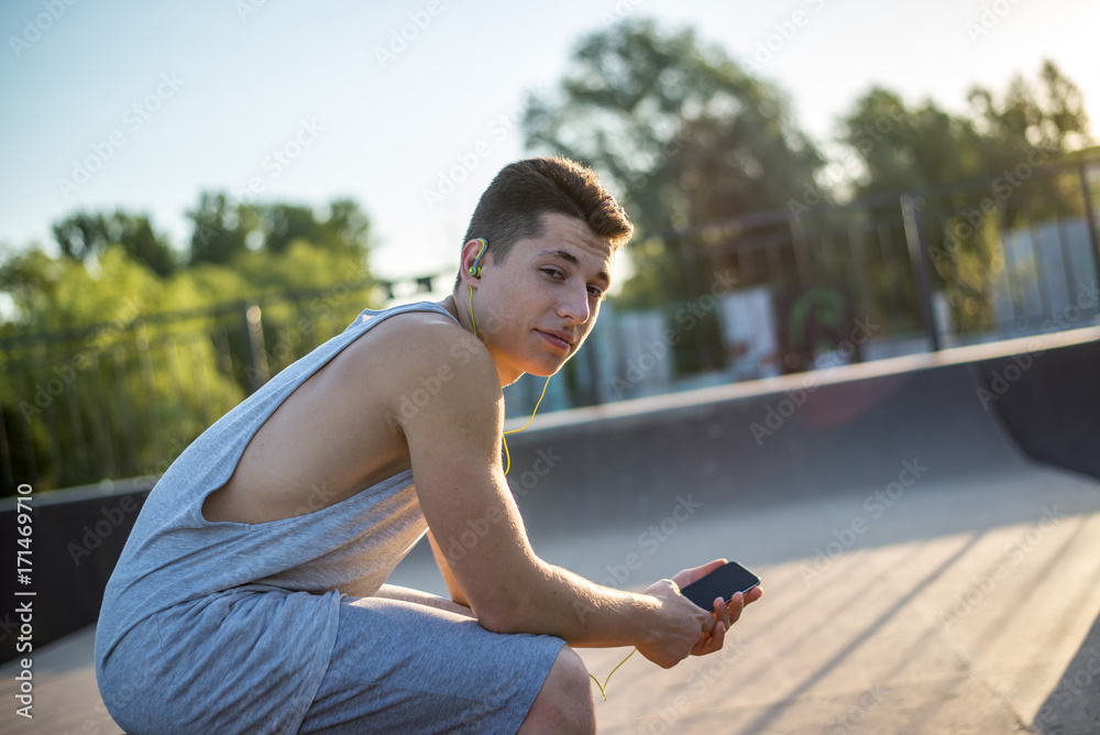A young guy listens to music before training