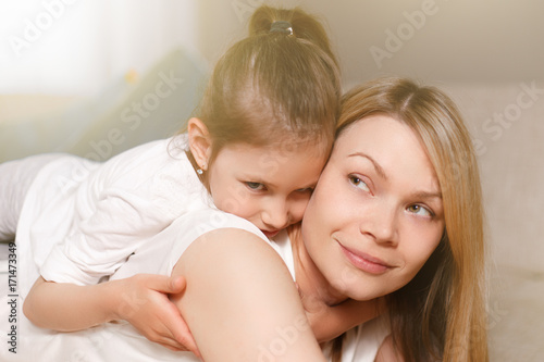 Mum and her cute daughter child girl are playing, smiling and hugging. Happy mother's day. Family holiday and togetherness.