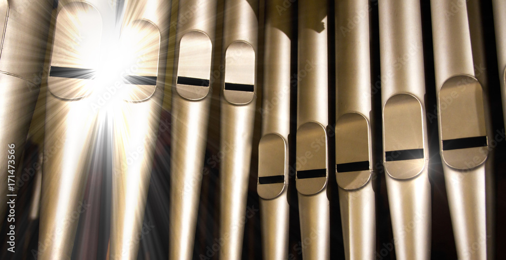 old organ pipes with a strong flash of light