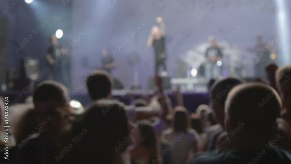 Mosh pit at the rock concert. Music stars at stage
