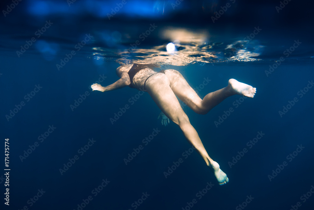 Woman swimming in sea. Underwater view