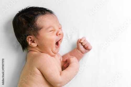 Baby laughing in bed