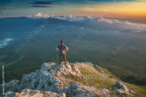Hiker standing on a rocky mountain top