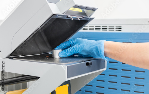 The scientist woman do test on mass spectrometer in chemistry lab photo