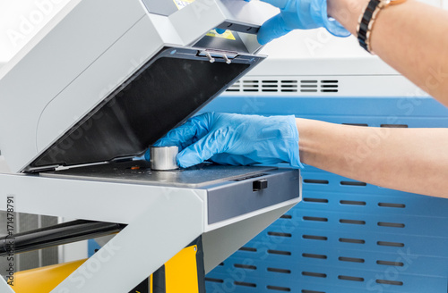 The scientist woman do test on mass spectrometer in chemistry lab photo