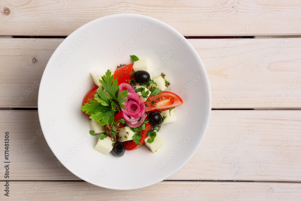 Salad with mozzarella, tomato and olives. Top view. Salad with mozzarella, tomato and olives. Top view.