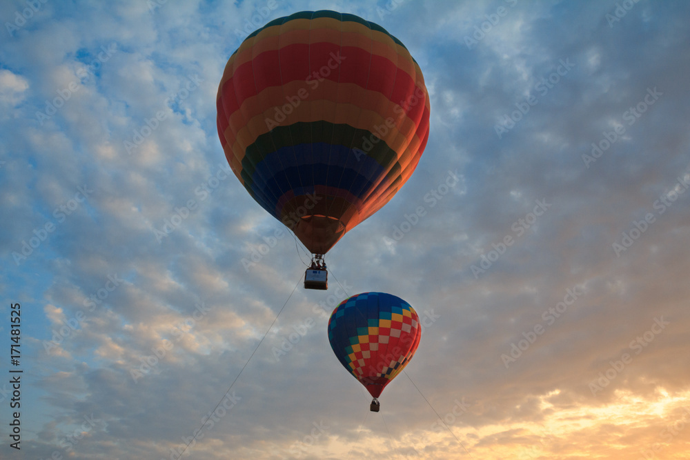 Naklejka premium Two colorful balloons in the sky at sunset. Hot air balloon.