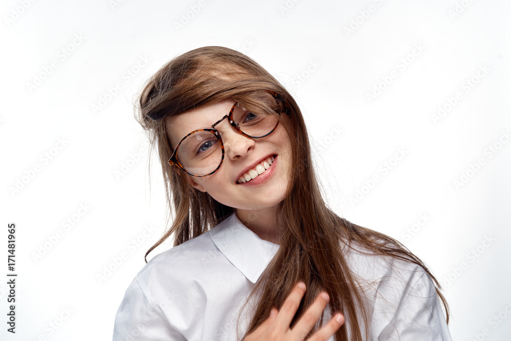 little girl with glasses and in shirt smiles, portrait