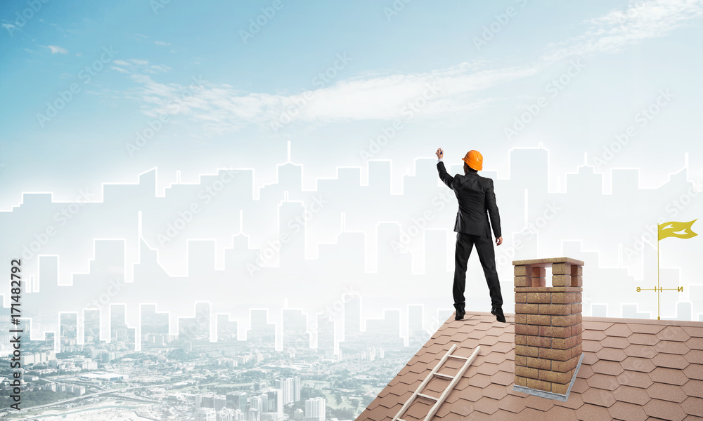 Man architect draw silhouette of modern city on blue sky. Mixed media Man architect draw silhouette of modern city on blue sky. Mixed media