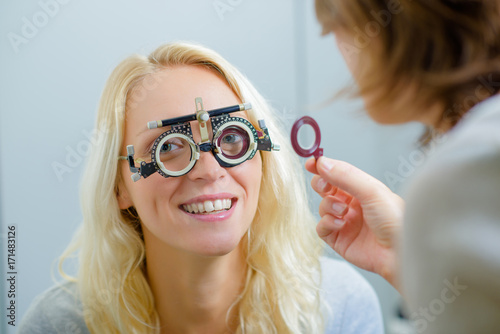 blonde smiling at camera against eye test