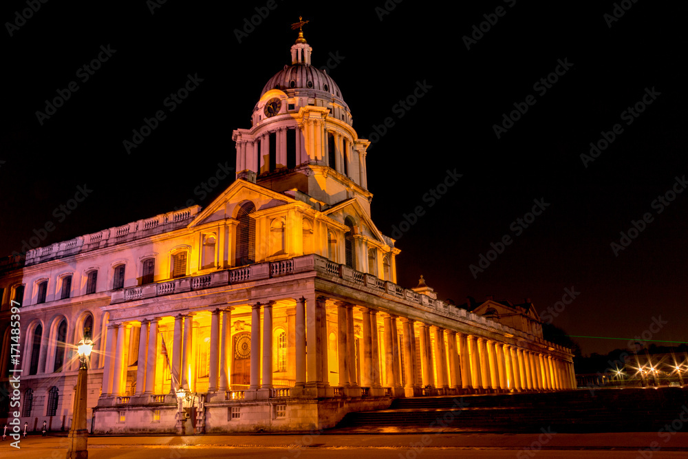 A night time image of the dome above the entrance of the Old Royal Naval College in Greenwich, London, England, United Kingdom, also showing the green laser line of the Greenwich Meridian GMT