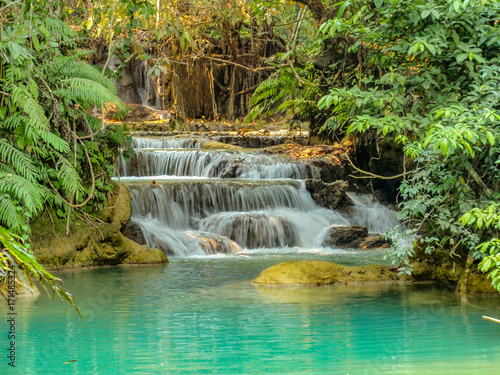 A tropical waterfall in the Erawan National Park near Kanchanaburi Thailand and the Myanmar border. It s a favourite spot for elephants  deer and swimming and is very tranquil and relaxing