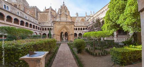 Mudejar cloister of Guadalupe Monastery with sundial. Panoramic view