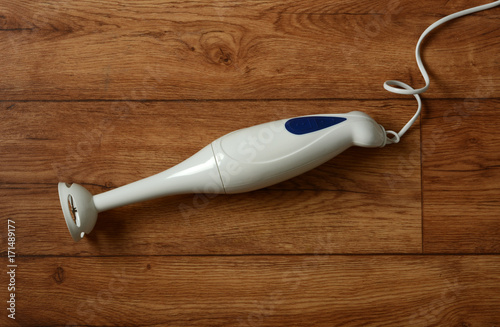 immersion blender on wooden table photo