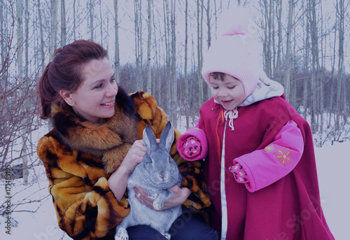 Rabbit hare outdoors snow cute kid little two parent childhood smiling young children happiness woman winter baby winter family ch photo