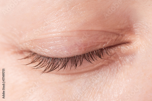 
Close up view of a closed woman eye - no make up photo