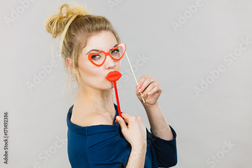 woman holds carnival accessories on stick