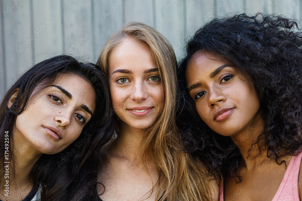 Close up portrait of three young women, looking at camera - obrazy, fototapety, plakaty 