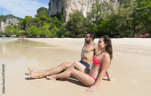 Couple On Beach Summer Vacation, Young People Sitting On Sand, Man Woman Sea Ocean Holiday Travel