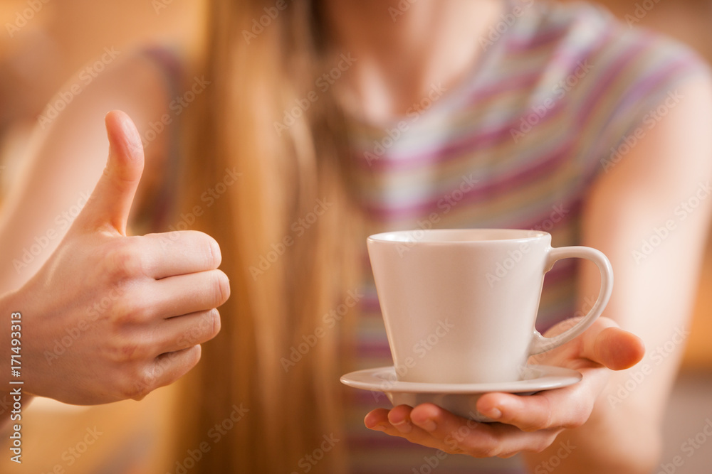 Happy woman holding cup of tea of coffee Happy woman holding cup of tea of coffee