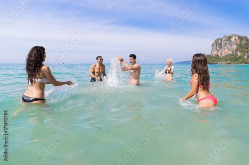Young People Group On Beach Summer Vacation, Happy Smiling Friends In Water Sea Ocean Holiday Travel