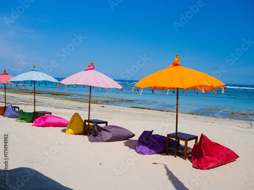 Beautiful sunny day with colorful umbrellas in a row in the beach of Pantai pandawa, in Bali island, Indonesia © Fotos 593