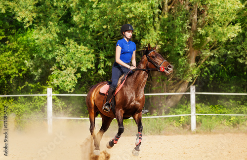 Jockey girl and show jumping horse at racetrack
