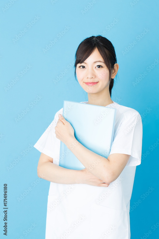 portrait of asian nurse isolated on blue background portrait of asian nurse isolated on blue background