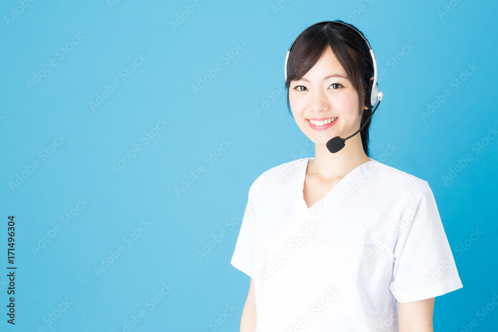 portrait of asian nurse isolated on blue background portrait of asian nurse isolated on blue background