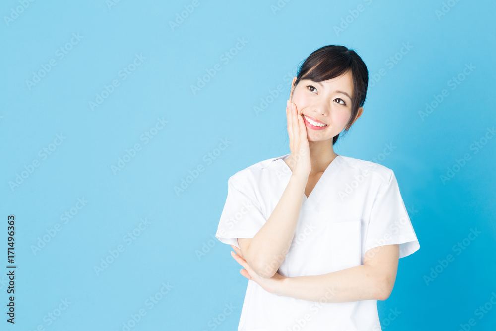 portrait of asian nurse isolated on blue background portrait of asian nurse isolated on blue background