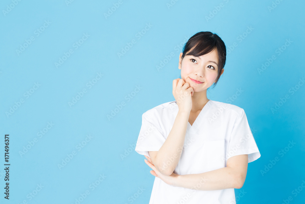 portrait of asian nurse isolated on blue background portrait of asian nurse isolated on blue background