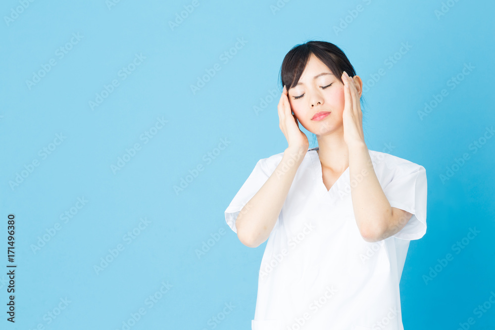 portrait of asian nurse isolated on blue background portrait of asian nurse isolated on blue background
