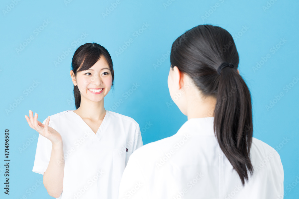 portrait of asian nurse isolated on blue background portrait of asian nurse isolated on blue background