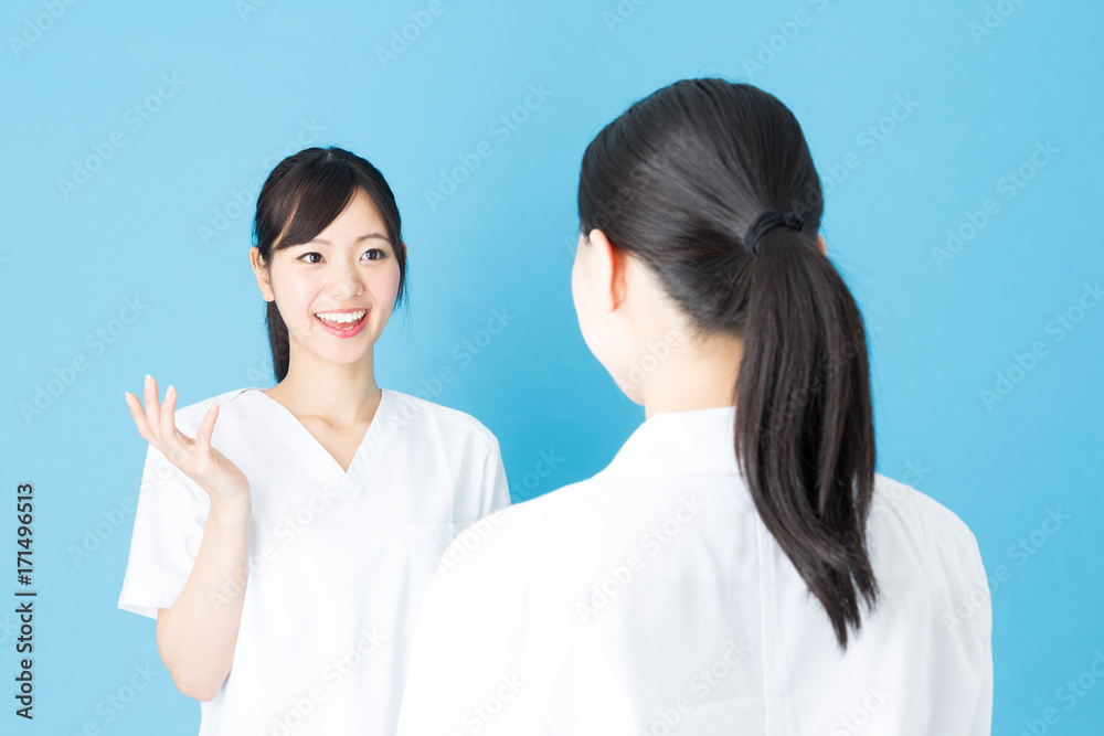 portrait of asian nurse isolated on blue background portrait of asian nurse isolated on blue background