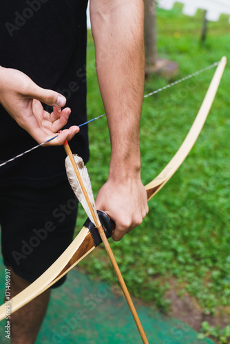 Crop man practicing archery in school photo