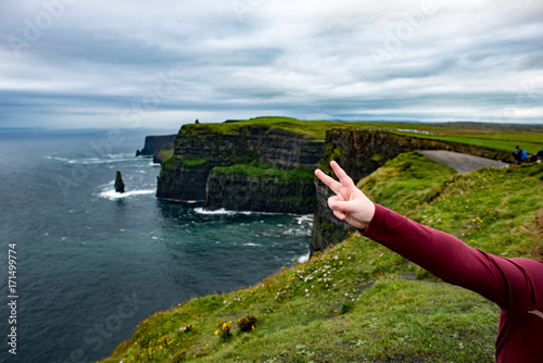 Girl at the Cliffs of Moher Tourist Attraction in Ireland