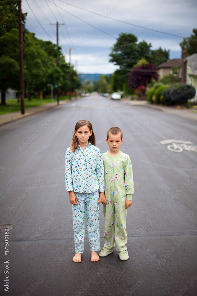 Pajama wearing children standing in the street Pajama wearing children standing in the street