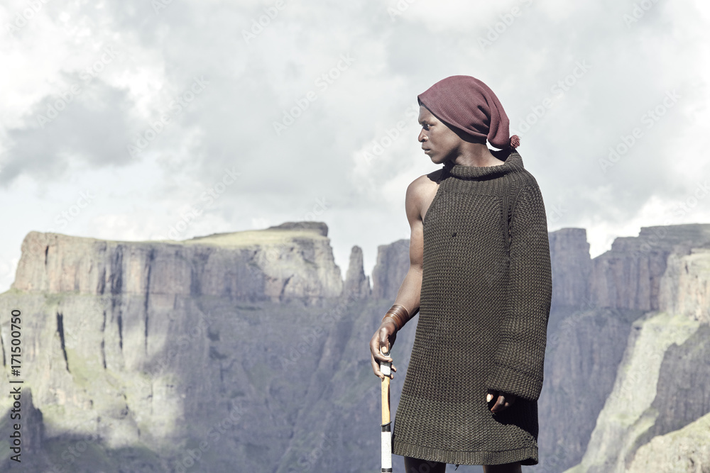 An epic portrait of a Bashoto shepherd standing in front of wild mountains. An epic portrait of a Bashoto shepherd standing in front of wild mountains.