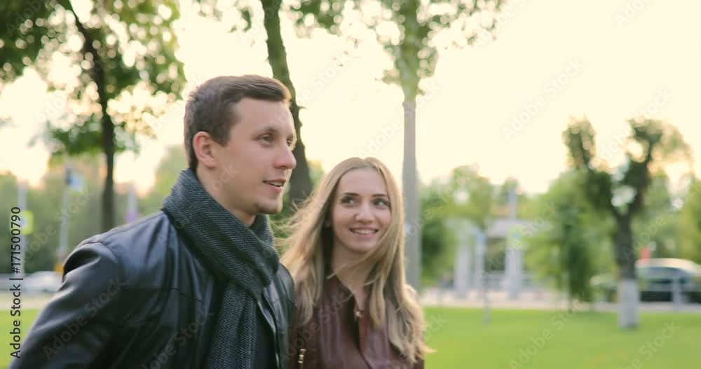 Happy couple in love walking in the park Happy couple in love walking in the park