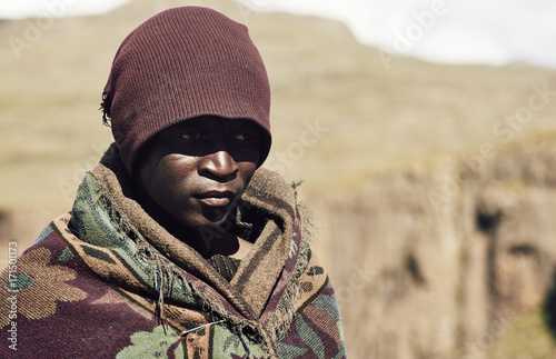 Portrait of a black Basotho shepherd wrapped in a traditional blanket.