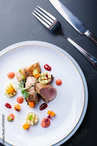 Duck breast with potato rosti,charred leeks,rhubarb puree,carrots and tayberry jelly. photo
